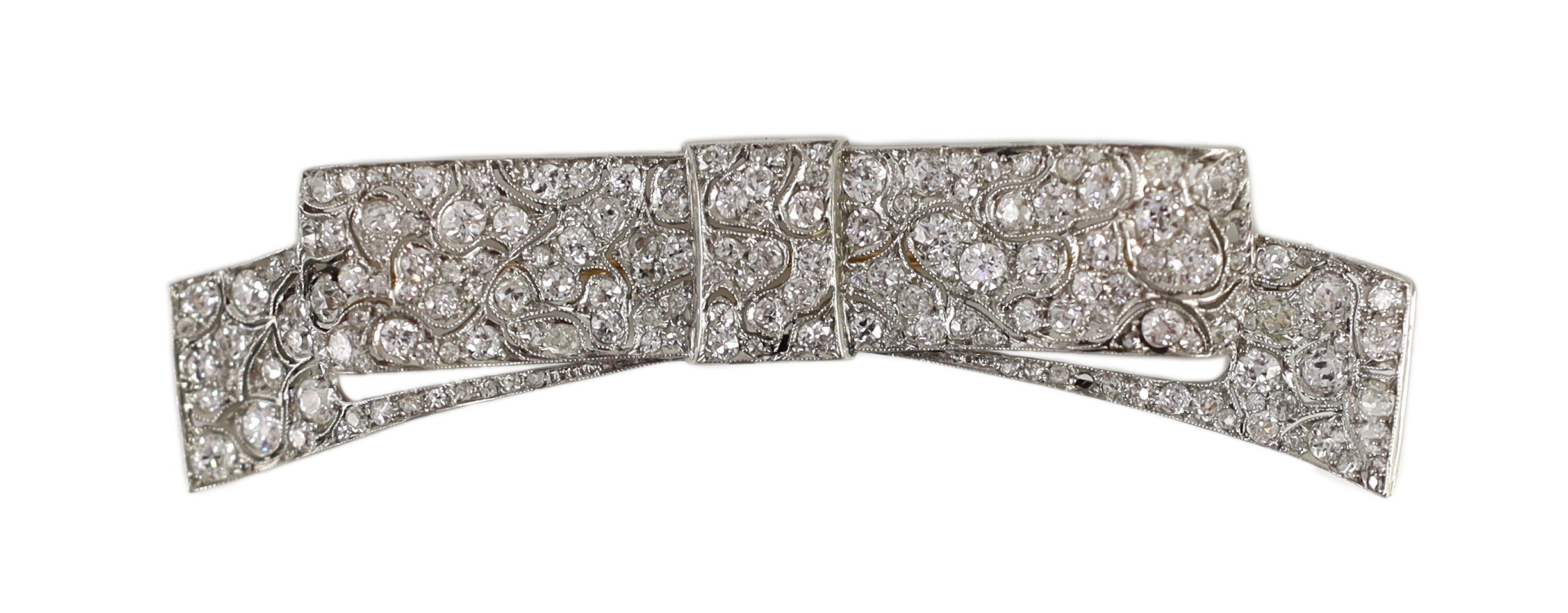 A mid 20th century white gold and pave set diamond ribbon bow brooch